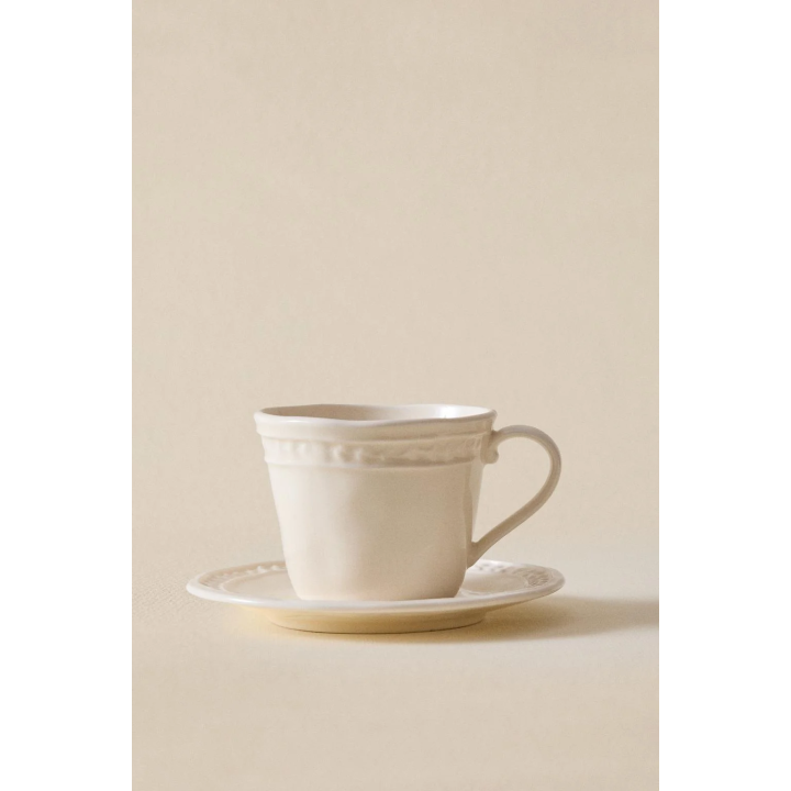 RAISED STONEWARE COFFEE CUP AND SAUCER