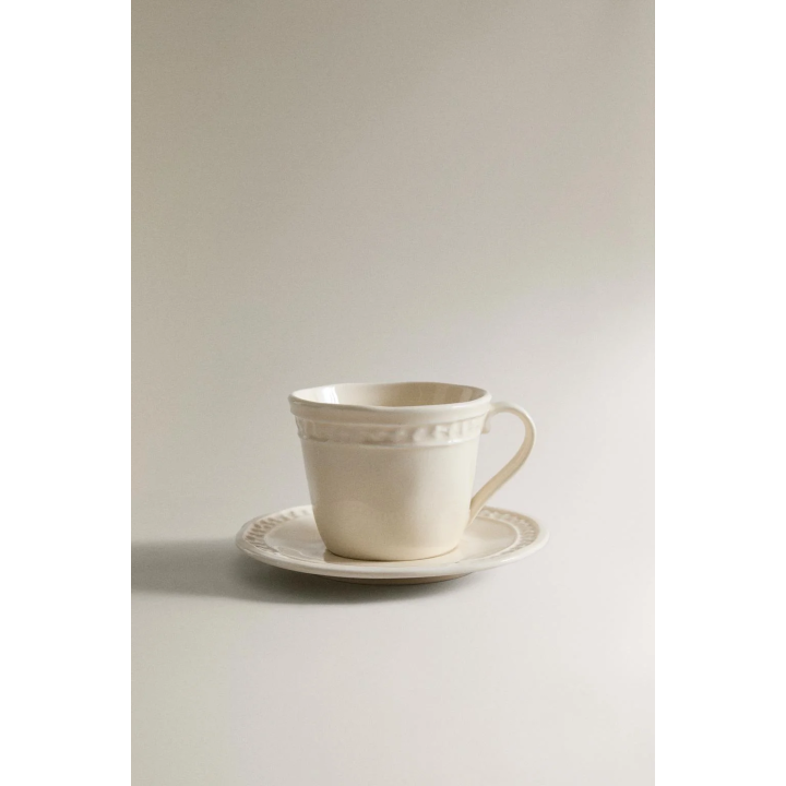RAISED STONEWARE COFFEE CUP AND SAUCER