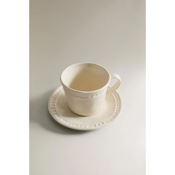 RAISED STONEWARE COFFEE CUP AND SAUCER