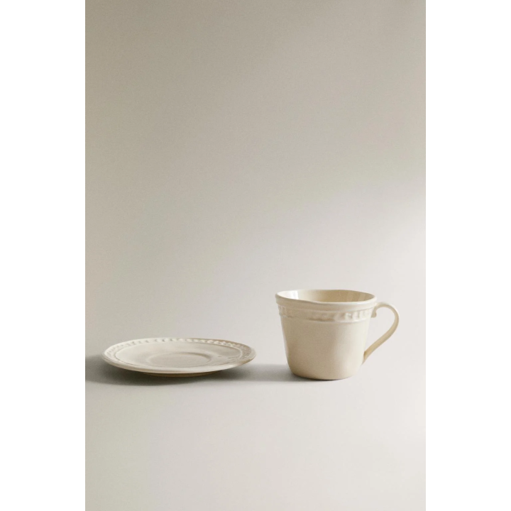 RAISED STONEWARE COFFEE CUP AND SAUCER