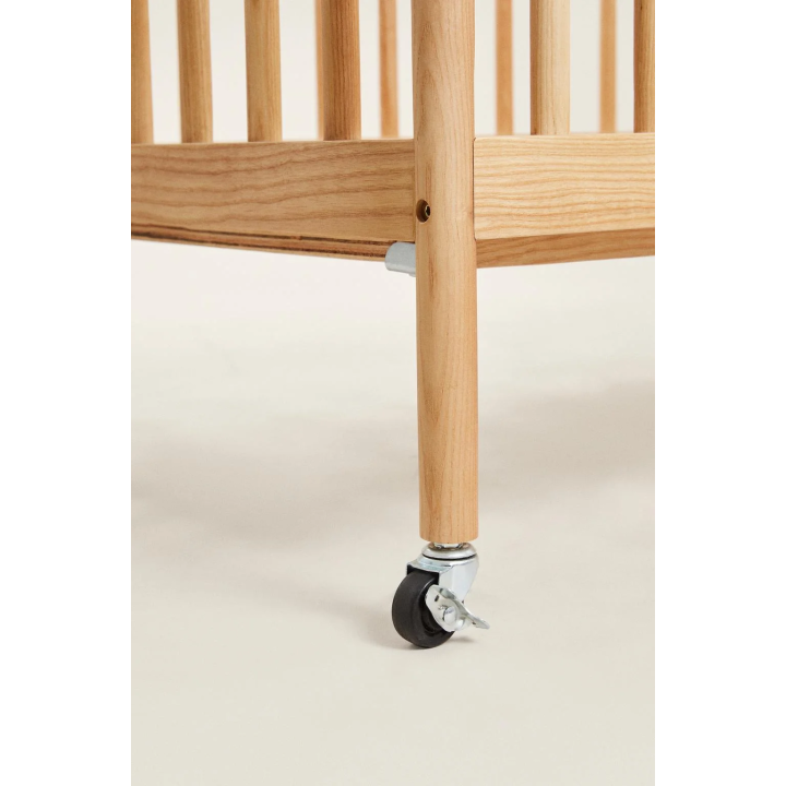 CARVED WOODEN COT WITH WHEELS