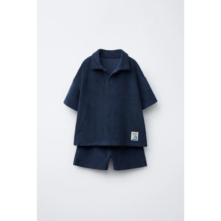 Комплект поло и бермуды из махровой ткани с лейблом