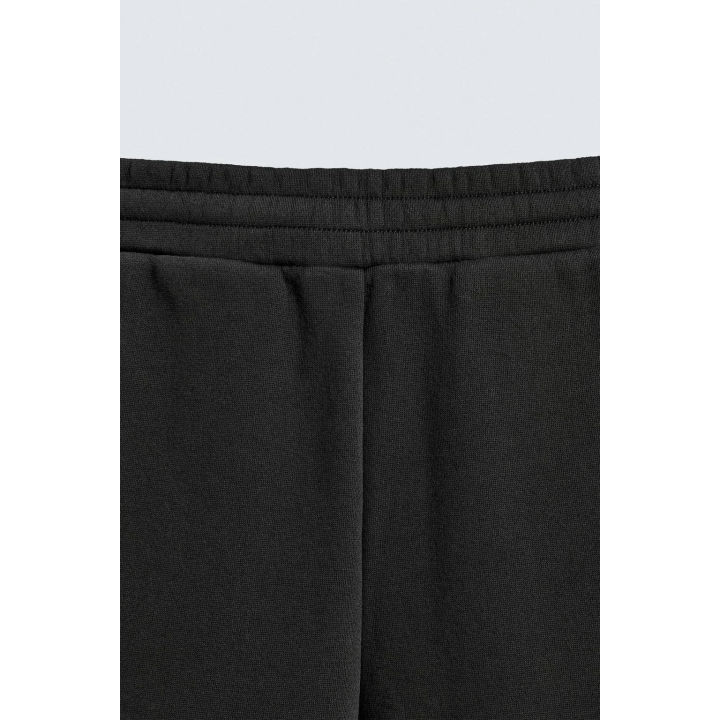 Брюки свободного кроя с плиссированными шарами эффекта неопрена