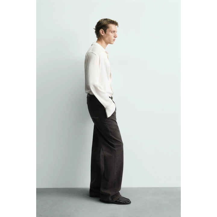 Джинсы с расклешенными штанинами и восковым покрытием