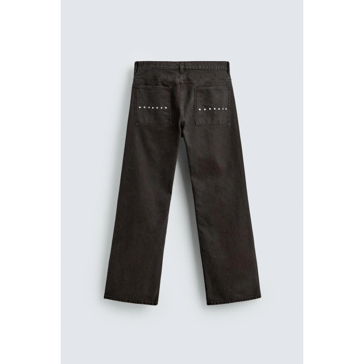 Джинсы с расклешенными штанинами и восковым покрытием