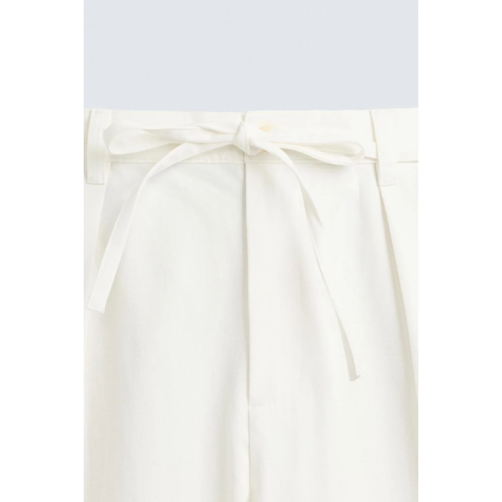 Брюки свободного кроя с защипами