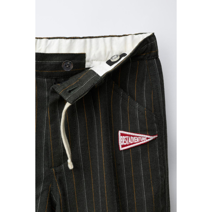 БРЮКИ В ПОЛОСКУ С НАШИВКОЙ