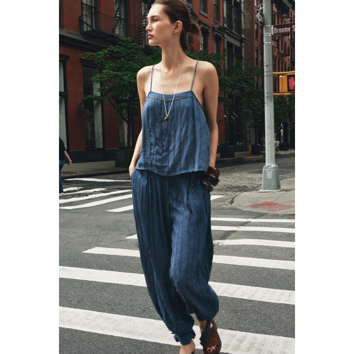 Брюки с бисером и завязками на подворотах