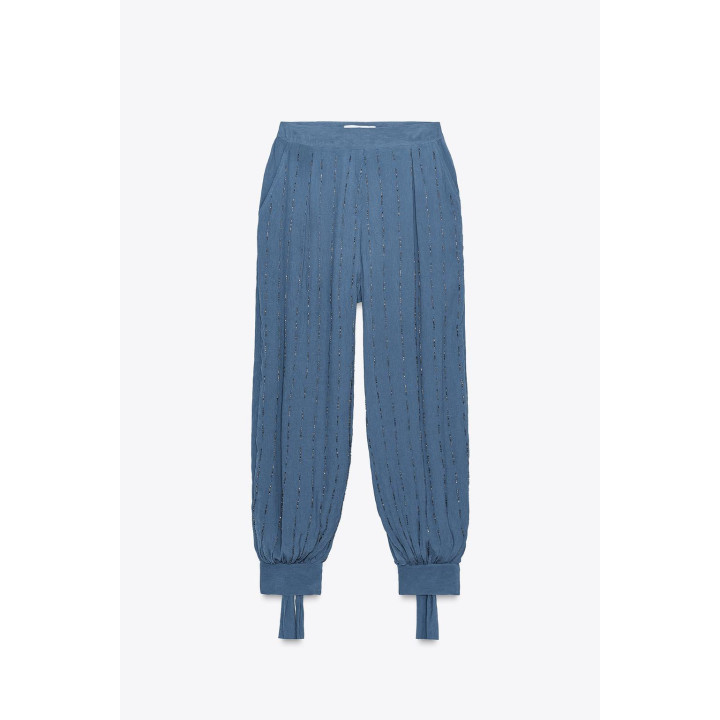 Брюки с бисером и завязками на подворотах