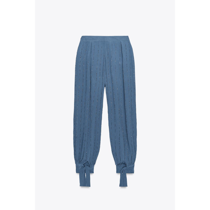 Брюки с бисером и завязками на подворотах