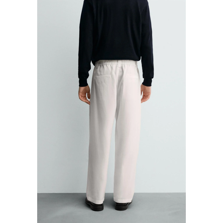 БРЮКИ ИЗ СТРУЯЩЕЙСЯ ТКАНИ СО СКЛАДКАМИ ПО БОКАМ