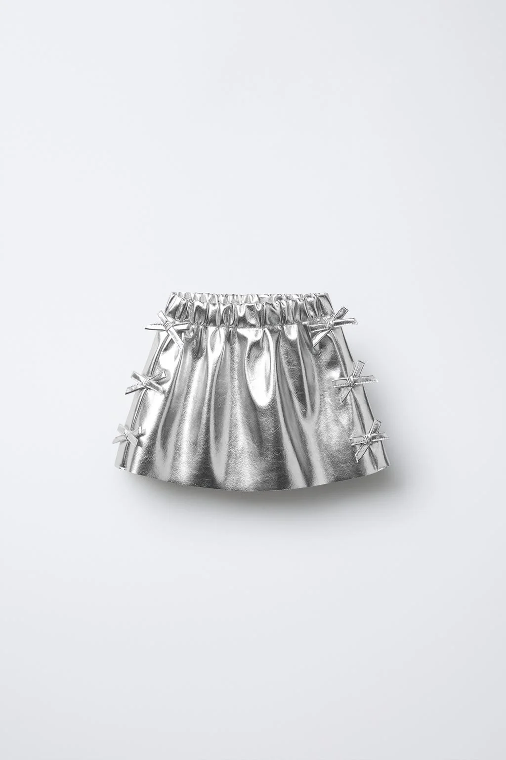 METALLIC SKIRT WITH BOWS